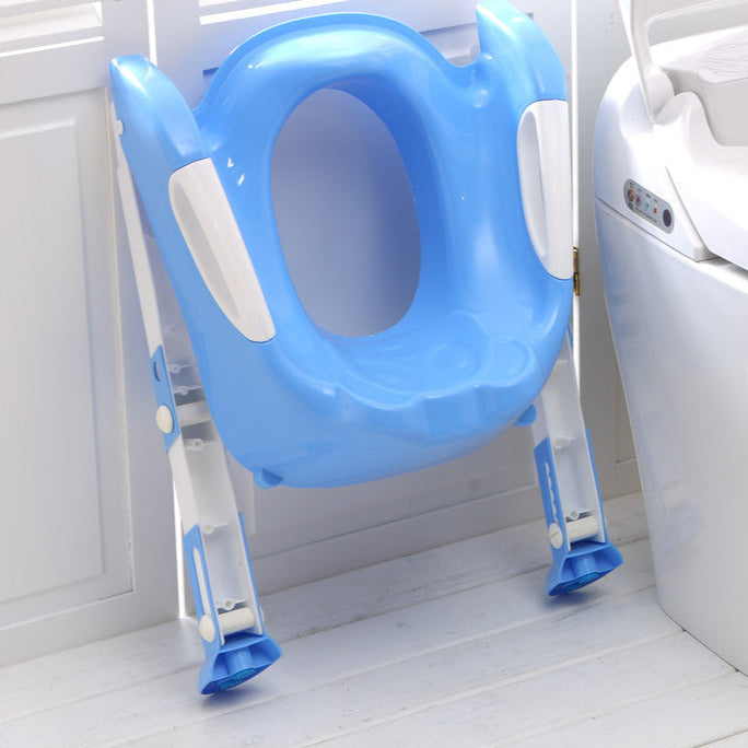 Blue children's toilet seat with adjustable stand next to a white toilet.