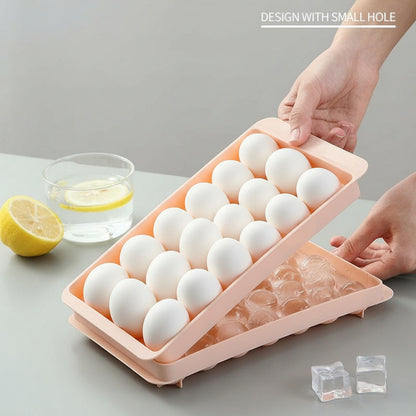 Person holding a pink ice freezing tray with small holes on a gray surface.