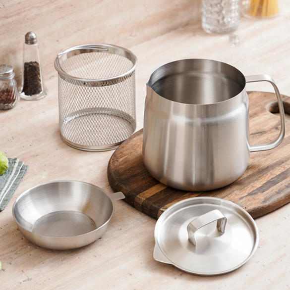 Set of stainless steel stainless steel oil pot strainer on a wooden surface.