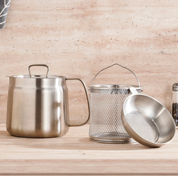 Set of stainless steel oil pot strainer on a wooden surface